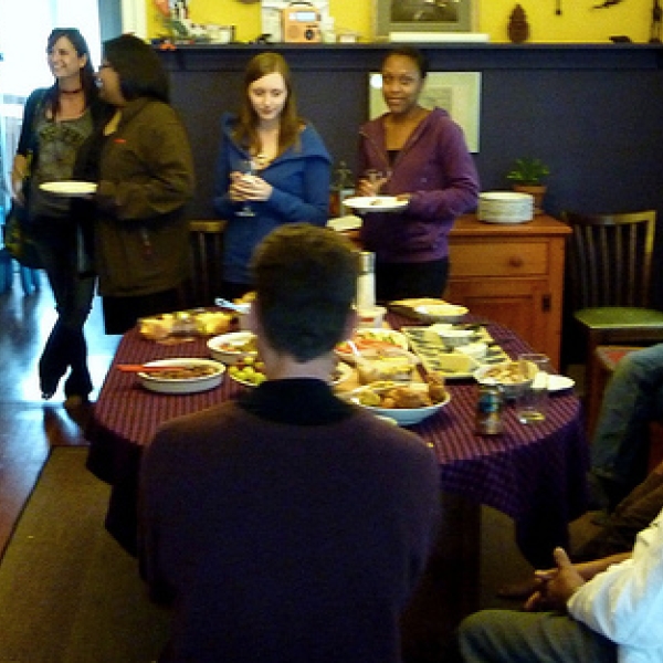 Where the action is ... food! Enjoying one another's company. Also in attendance were the Tanzania field school students, and the children and partners of faculty and graduates.