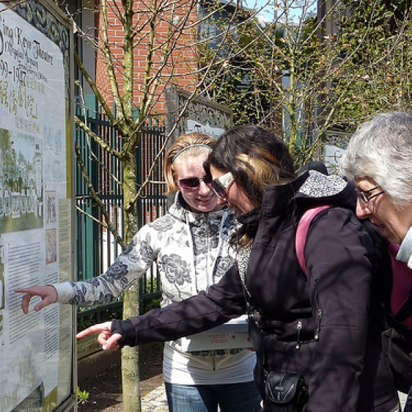 Historic sign boards - Shanghai Alley Audrea, Kairis, and Susan reading the sign boards.