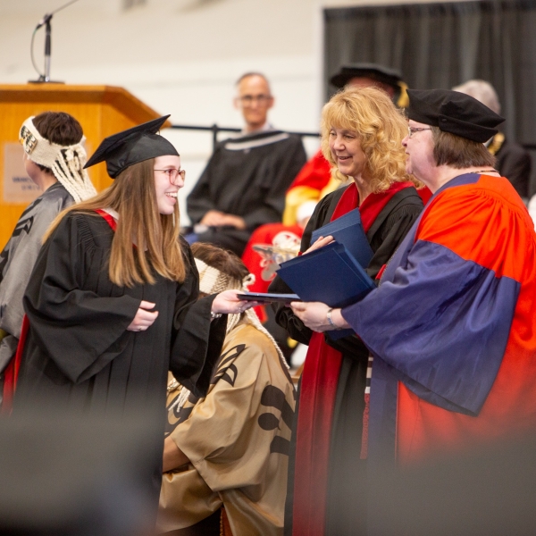 Convocation 2022, June 24: Megan receiving her degree from Deans Brimacombe and Stanley.