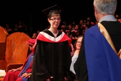 Julia receiving degree from John Black, Dean of Social Sciences