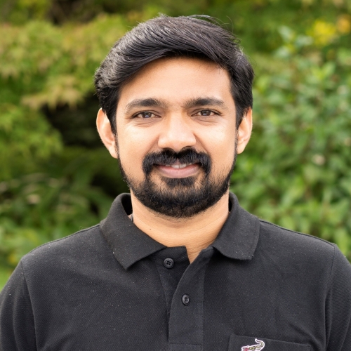 Rahul Parameswaran smiling outdoors.