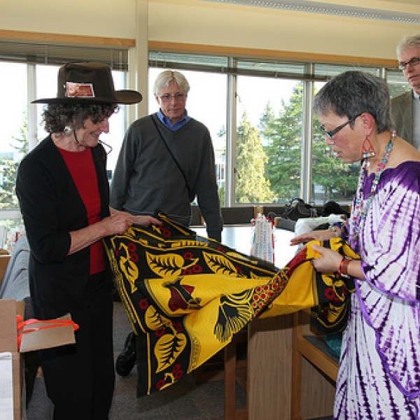 Gay receives a Tanzanian kanga from Imogene John and Steve in background. Photo courtesy of JA.