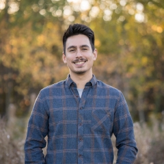 Smiling young man with short dark hair 